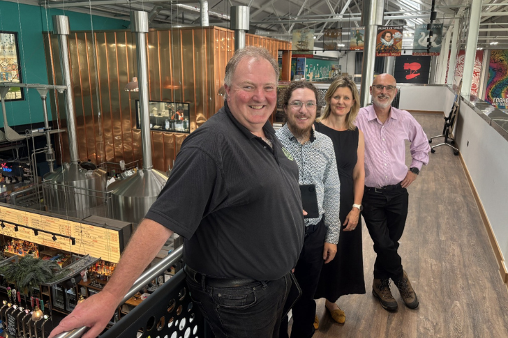 The Little Green Consulting team at Wells family brewery. Smiling and stood in a row.