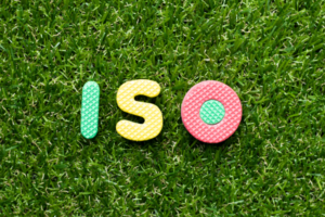Foam letters 'ISO' in multi-colours laid out on grass